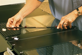 Interloc Lok-Bar being placed on a couchtop